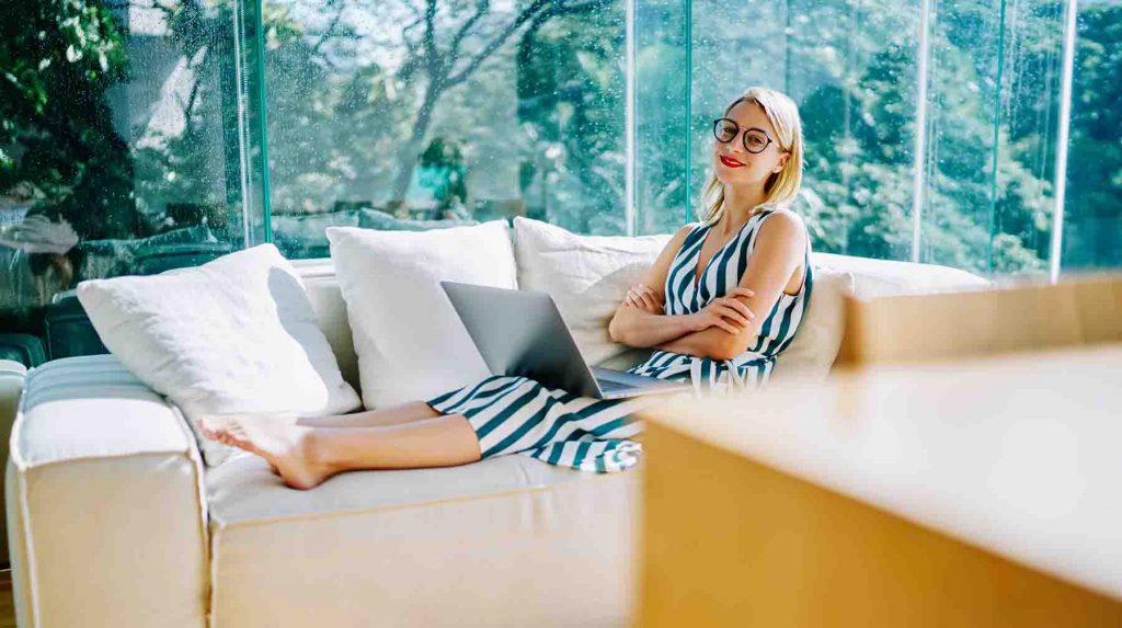 woman on sofa in class conservatory