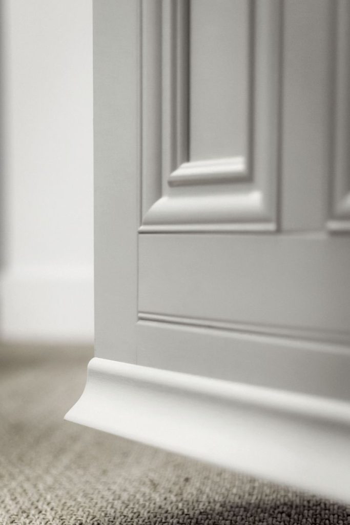 Detail view of a Residence Collection entrance door showing the deep bottom rail and drip bar design.