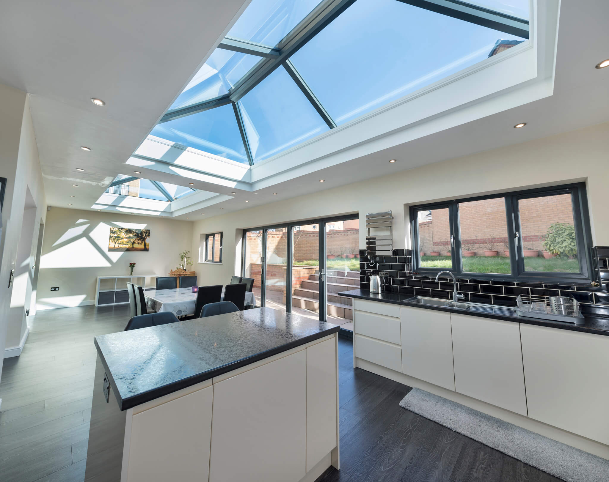 Internal shot of Orangery with kitchen island Roof Lantern in roof